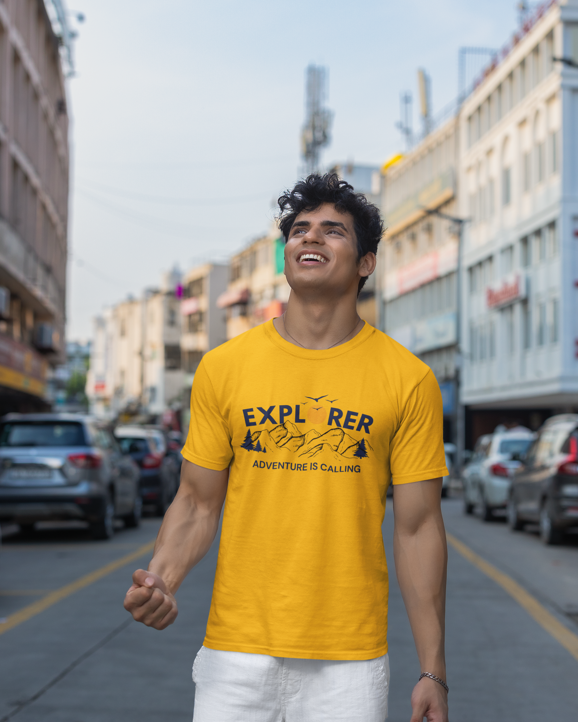 Man wearing a yellow t-shirt with text on a city street
