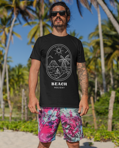 Man wearing a black t-shirt with 'Beach Holiday' design and colorful shorts on a beach.