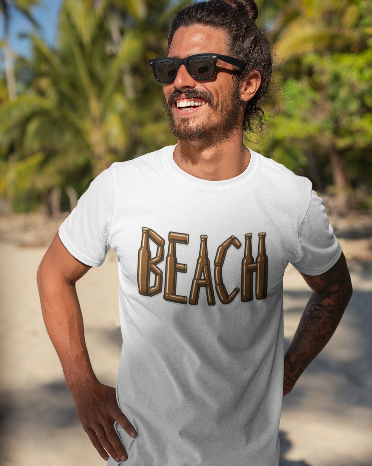 Man wearing a white t-shirt with 'BEACH' printed on it, standing on a beach.