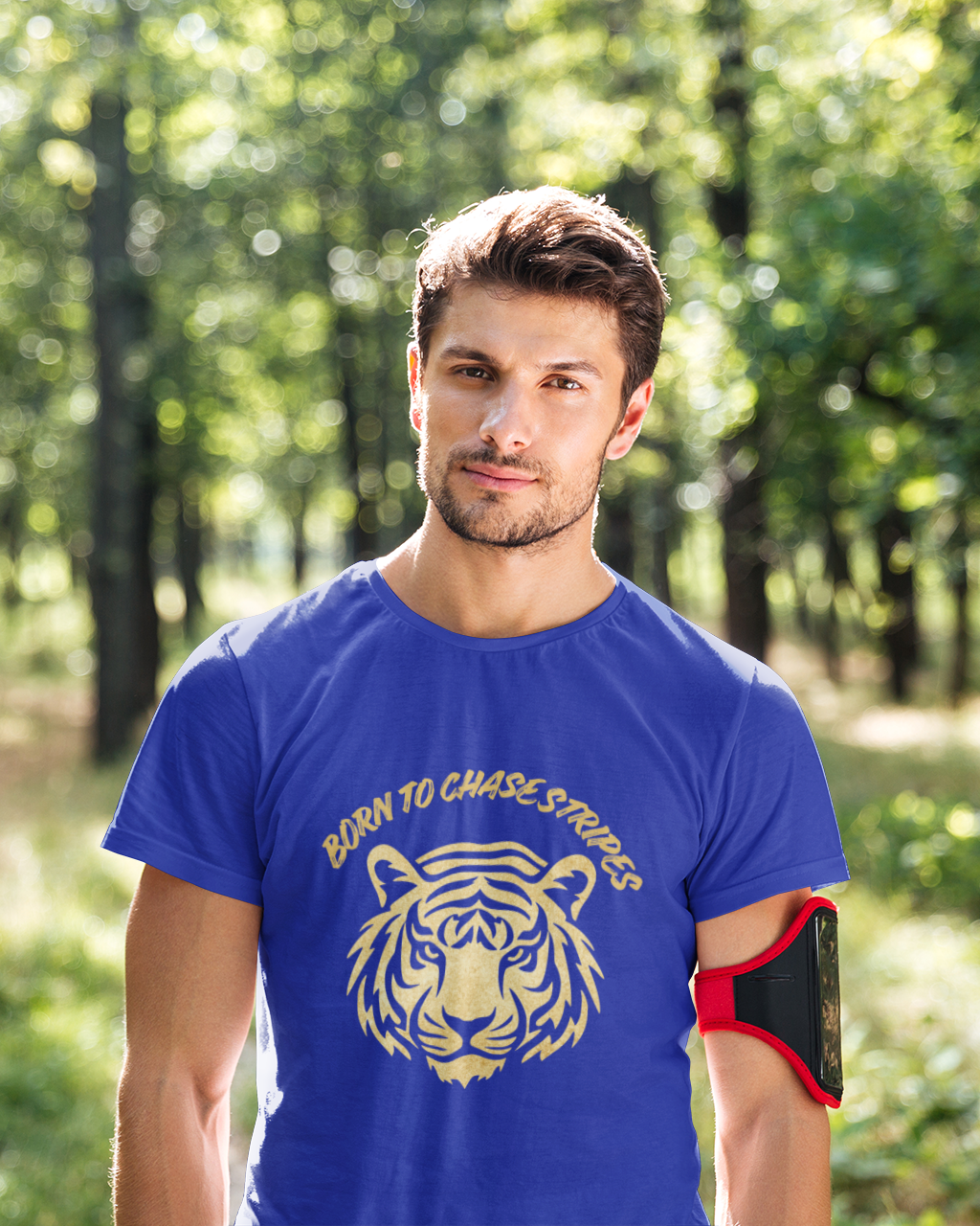 Man wearing a blue t-shirt with a tiger design in a forest