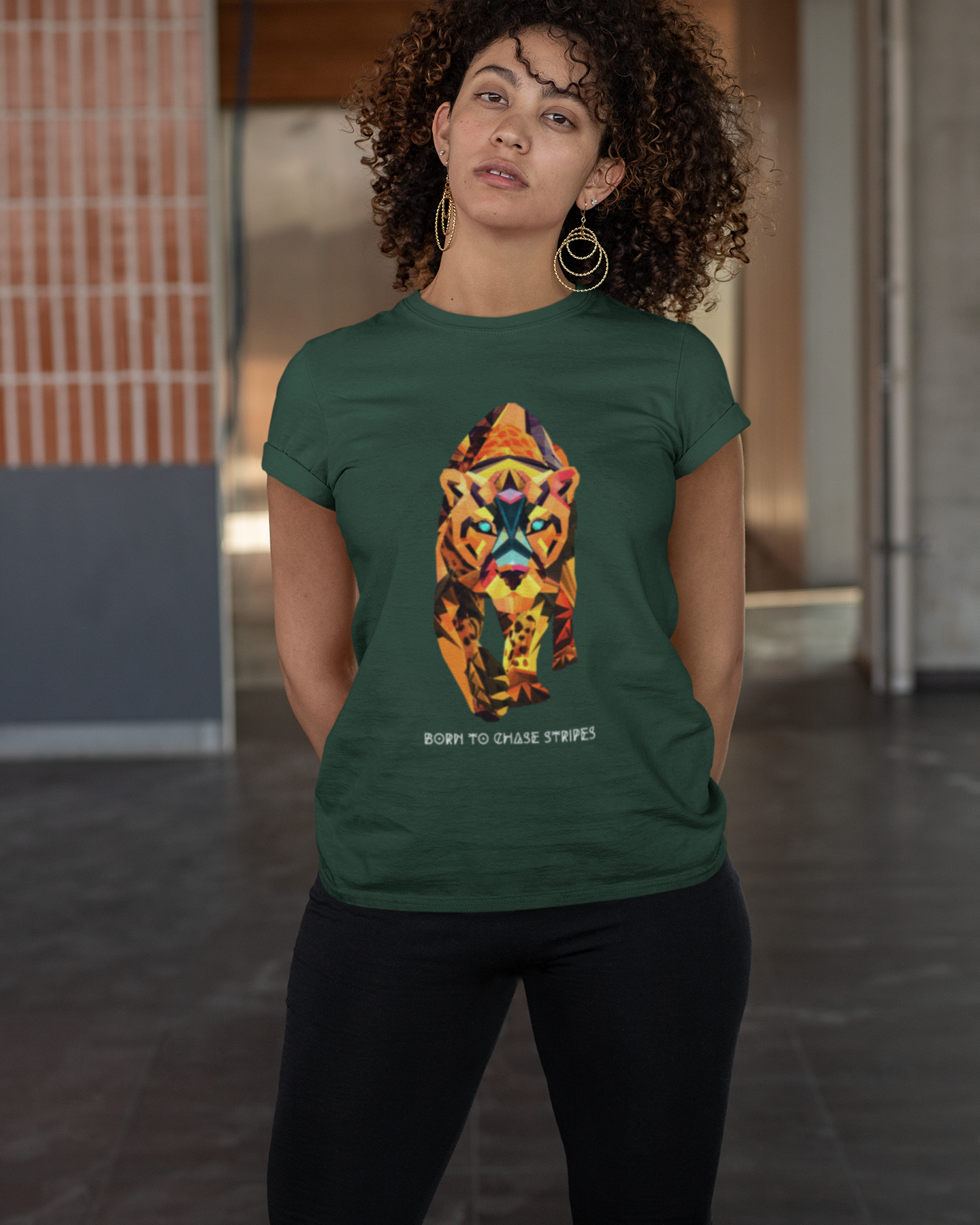 Person wearing a green t-shirt with a colorful tiger design in an indoor setting