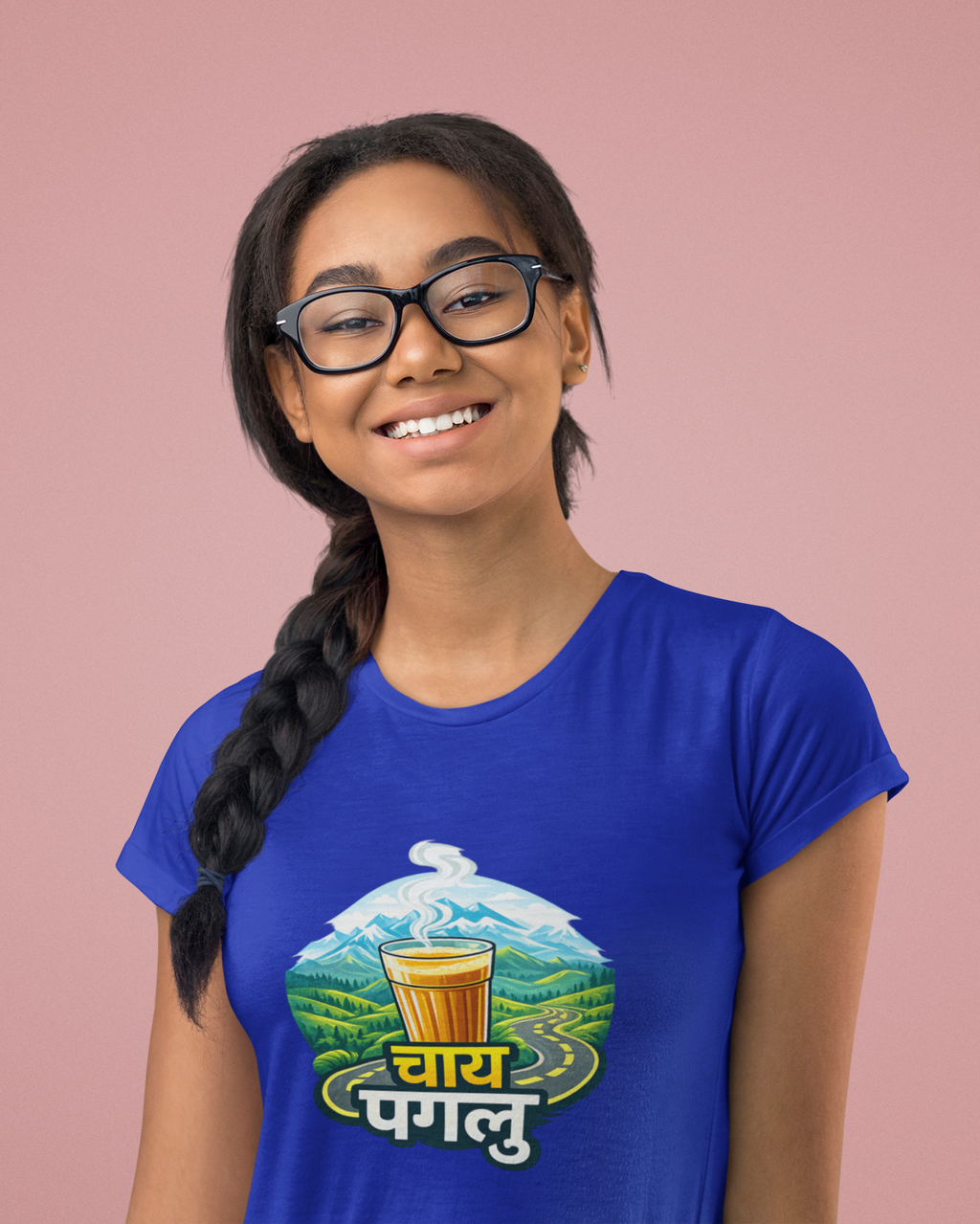 Girl wearing a blue t-shirt with a graphic design on a pink background