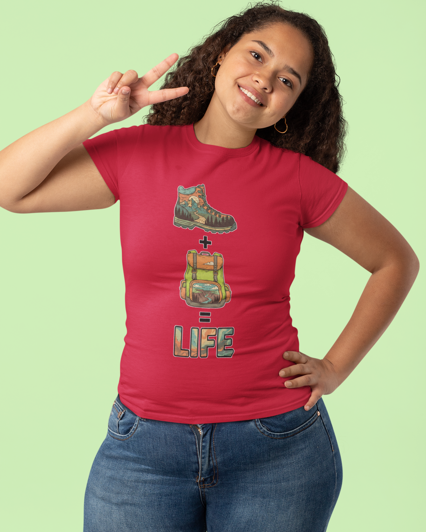 Person wearing a red t-shirt with a graphic design on a light green background