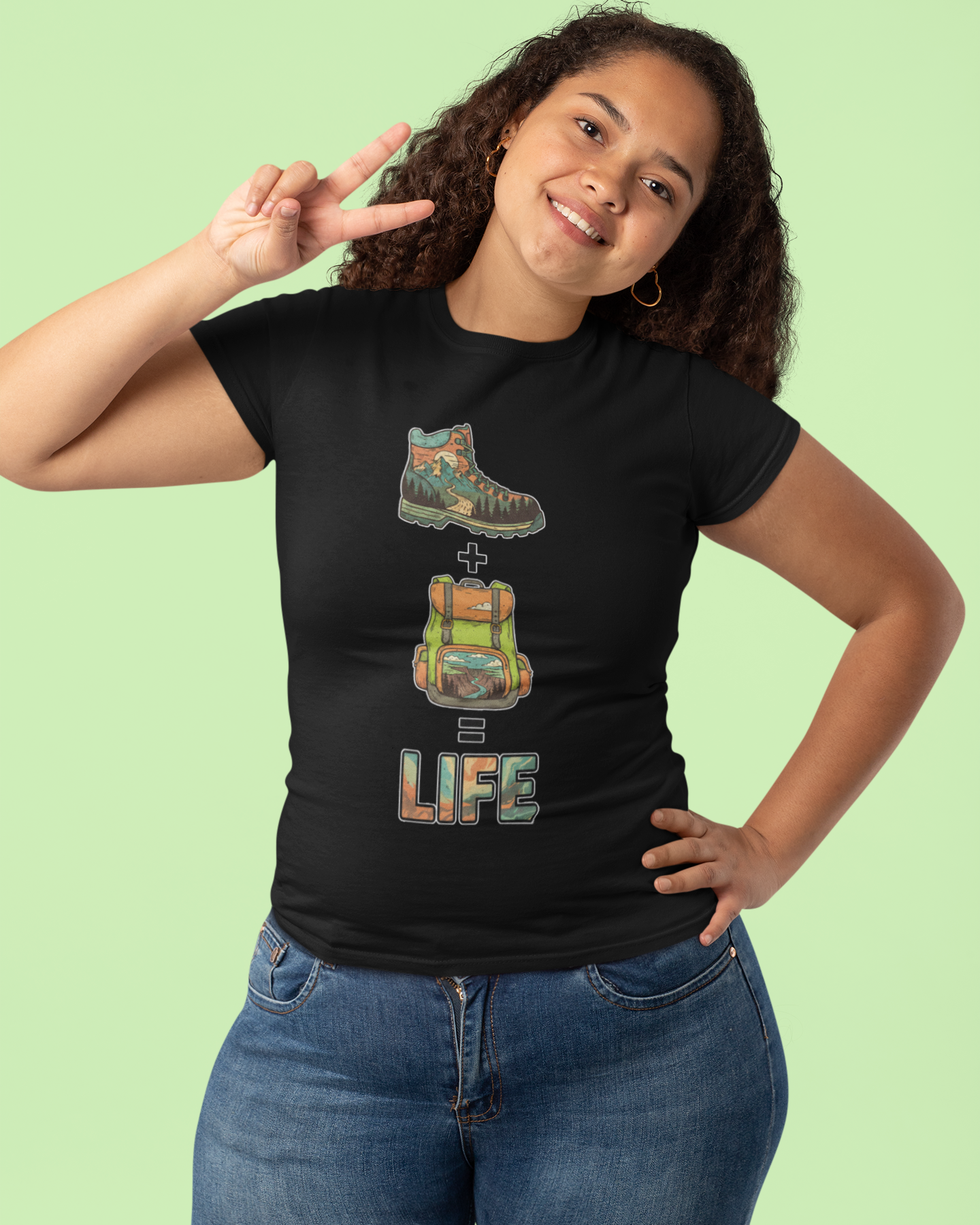 Person wearing a black t-shirt with a graphic design and text on a light green background