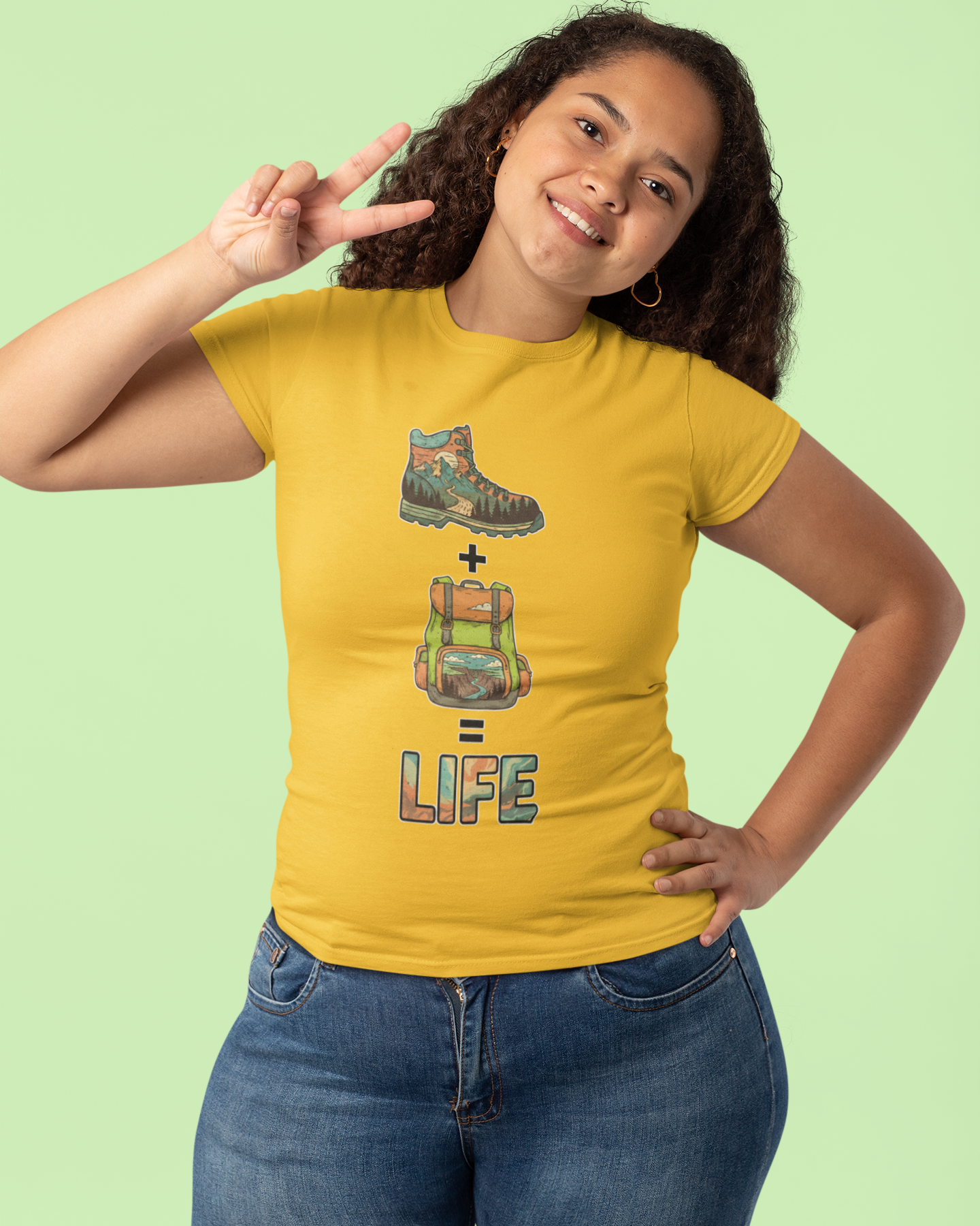 Person wearing a yellow t-shirt with a graphic design on a light green background