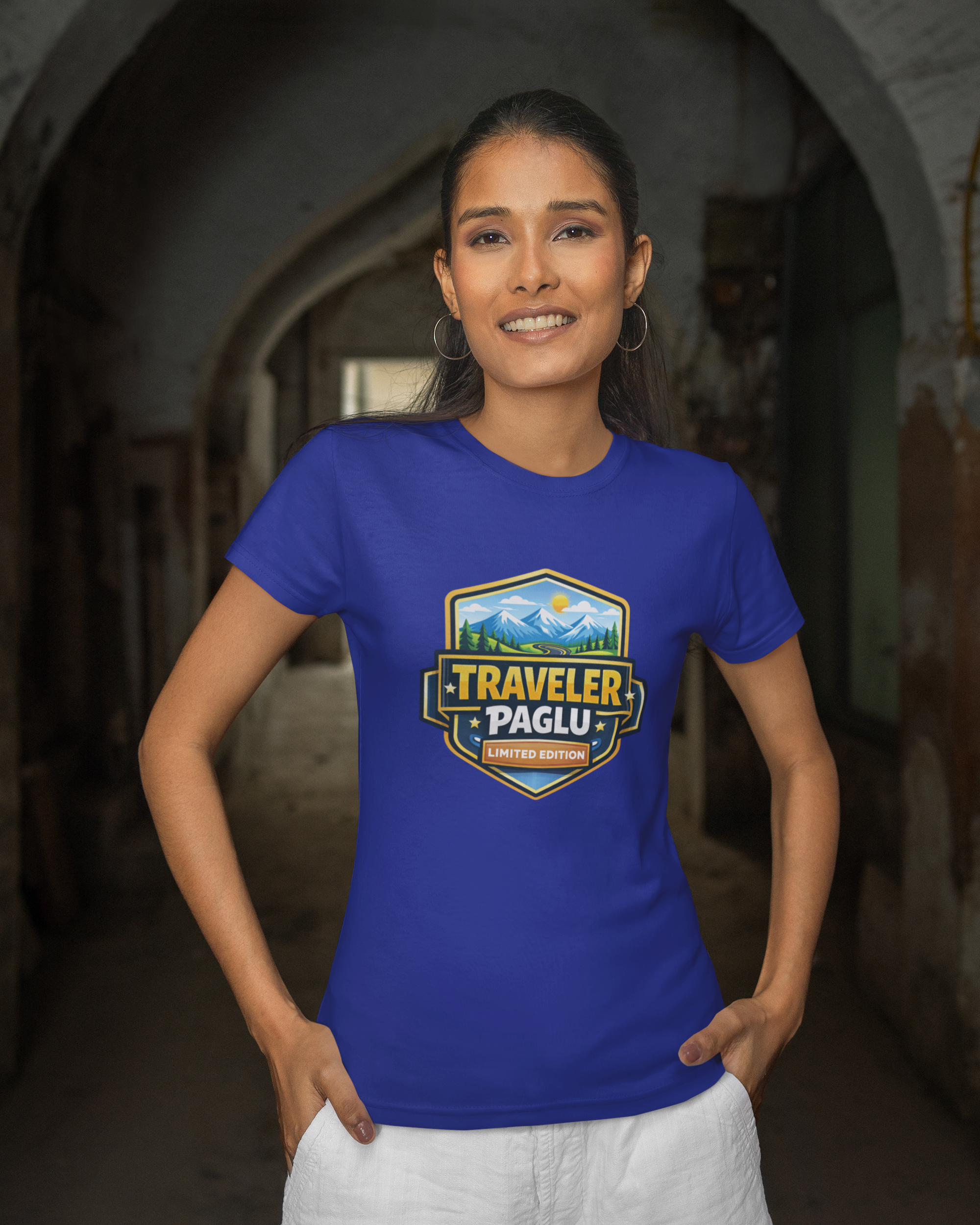 Woman wearing a blue t-shirt with 'Traveller Paglu' logo in an archway.