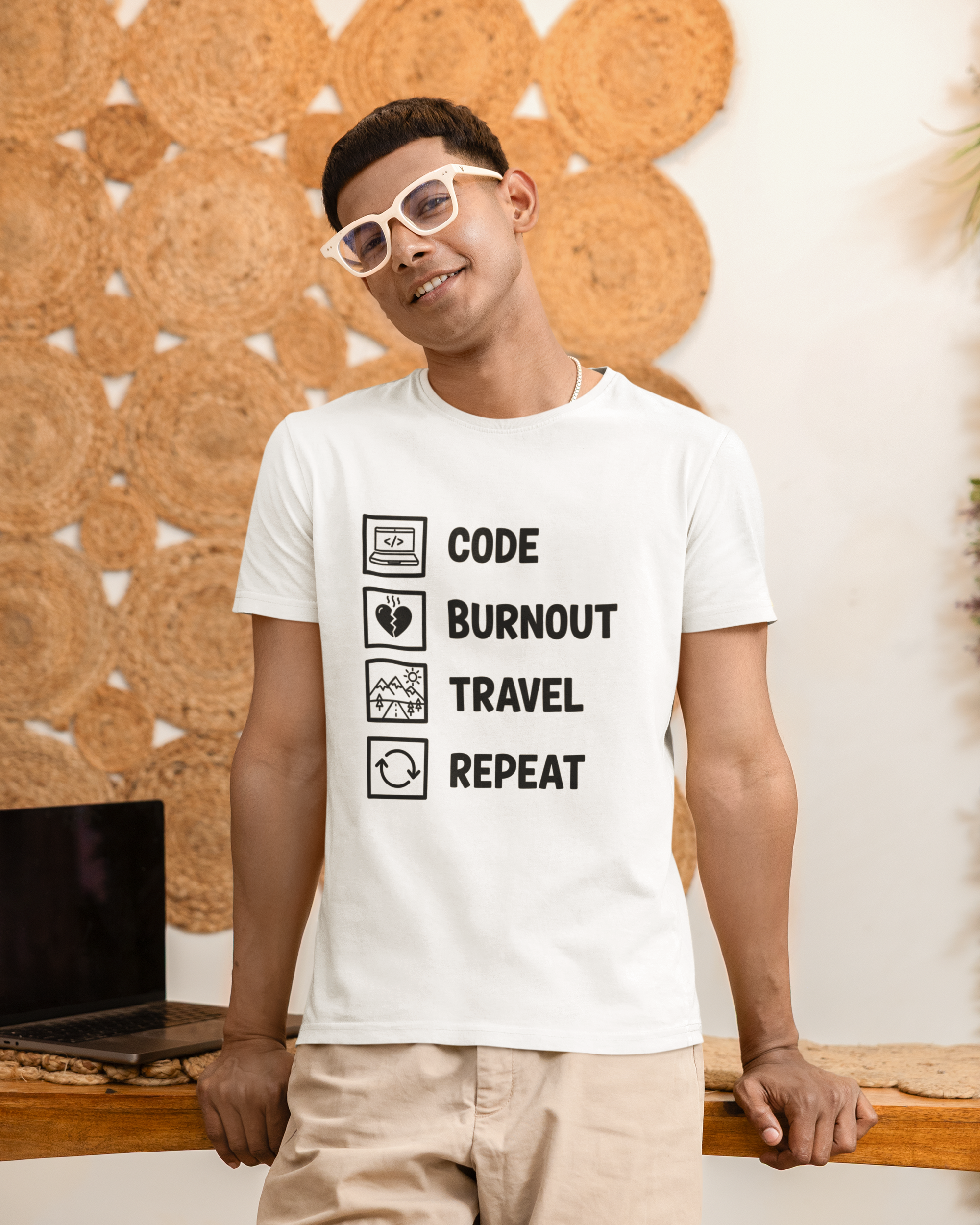 Person wearing a white t-shirt with text design, standing against a textured wall.