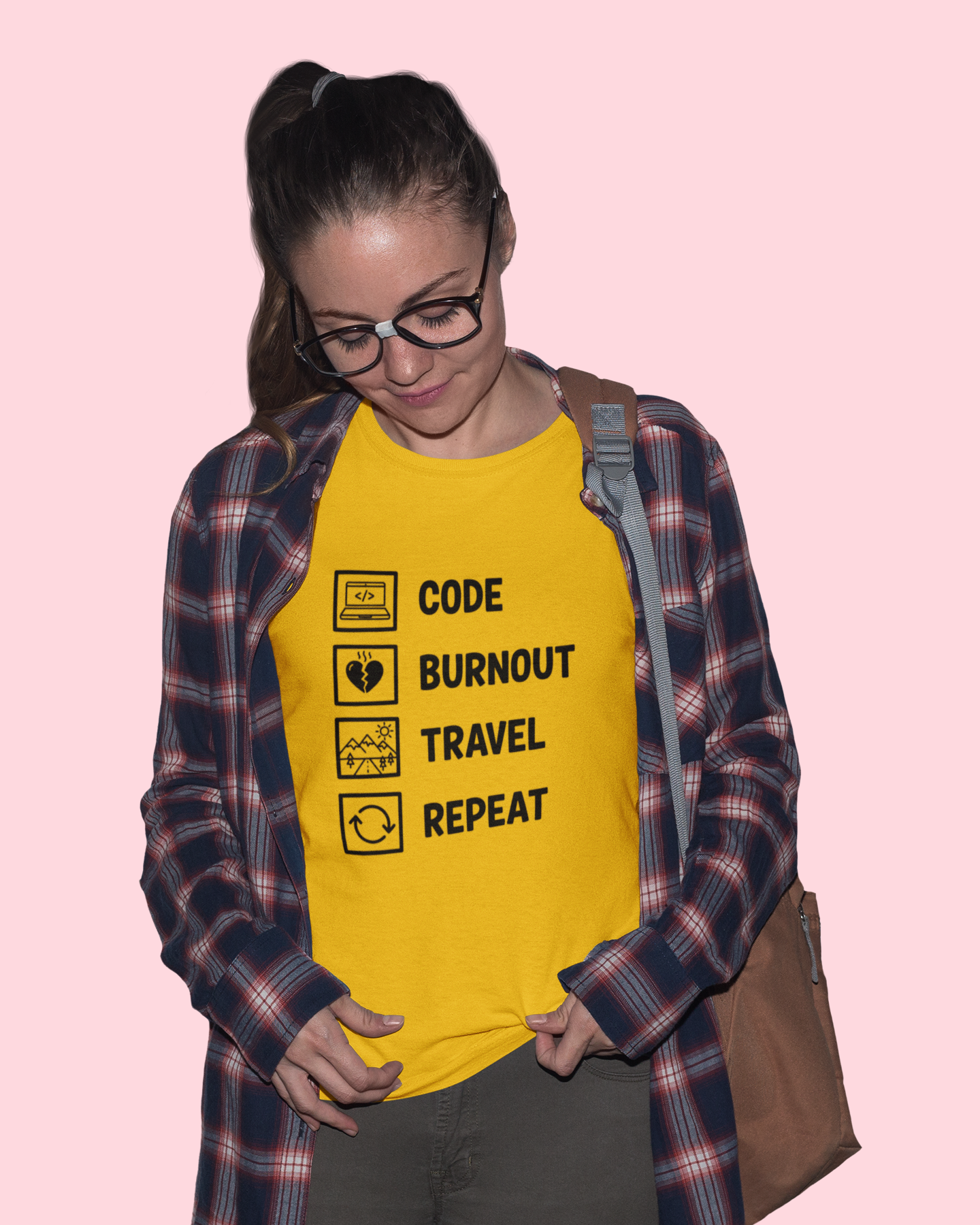 Person wearing a yellow t-shirt with text on a pink background