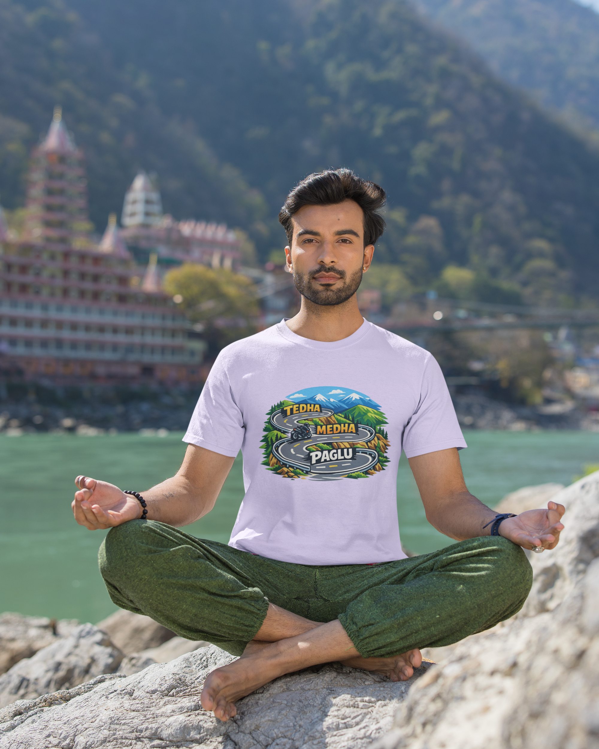 Man meditating on a rock with a scenic background featuring mountains and a temple.