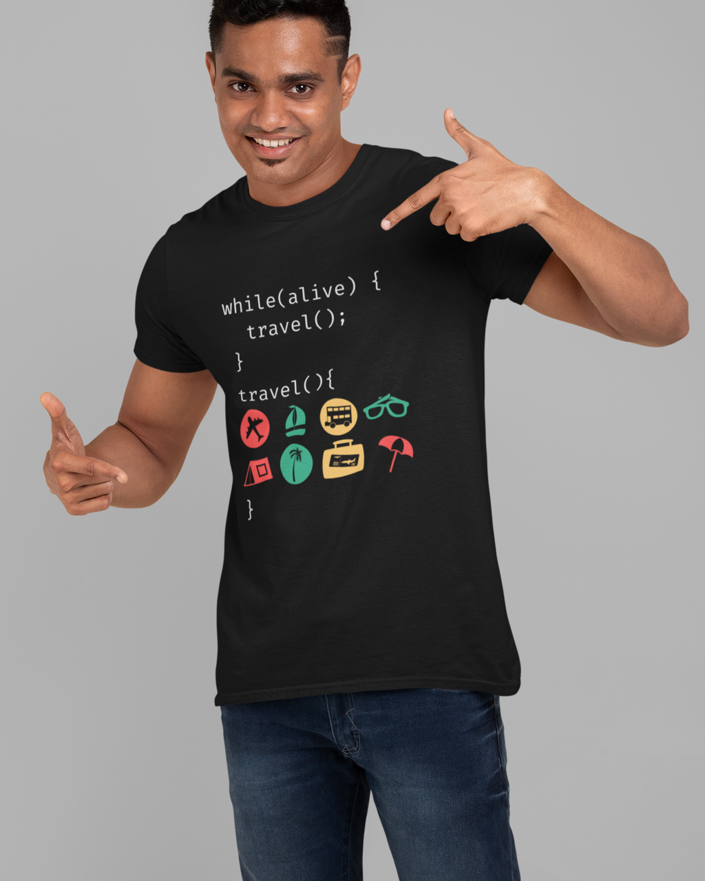 Man wearing a black t-shirt with travel-themed code design, pointing at the shirt.