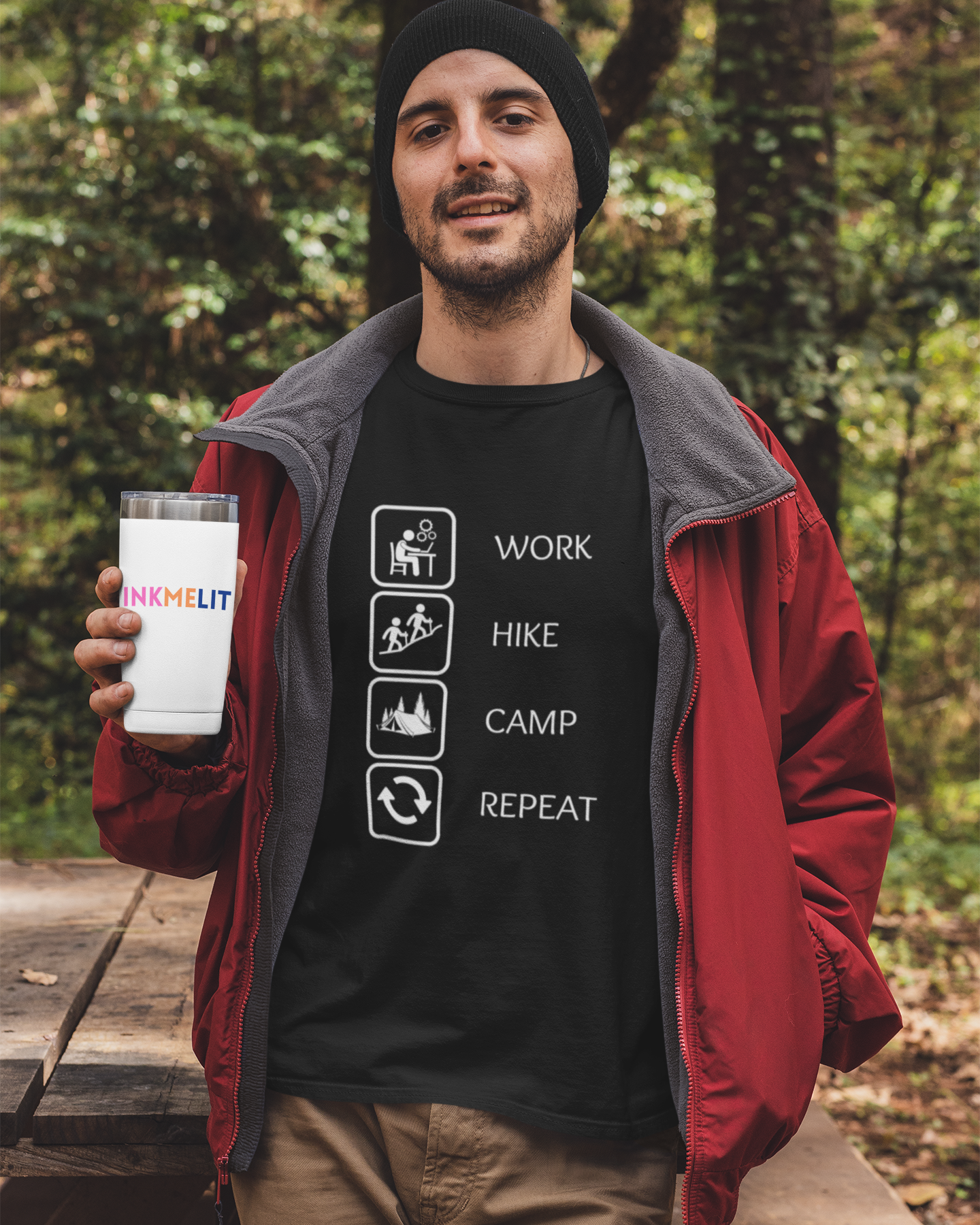 Man holding a branded cup outdoors with a forest background