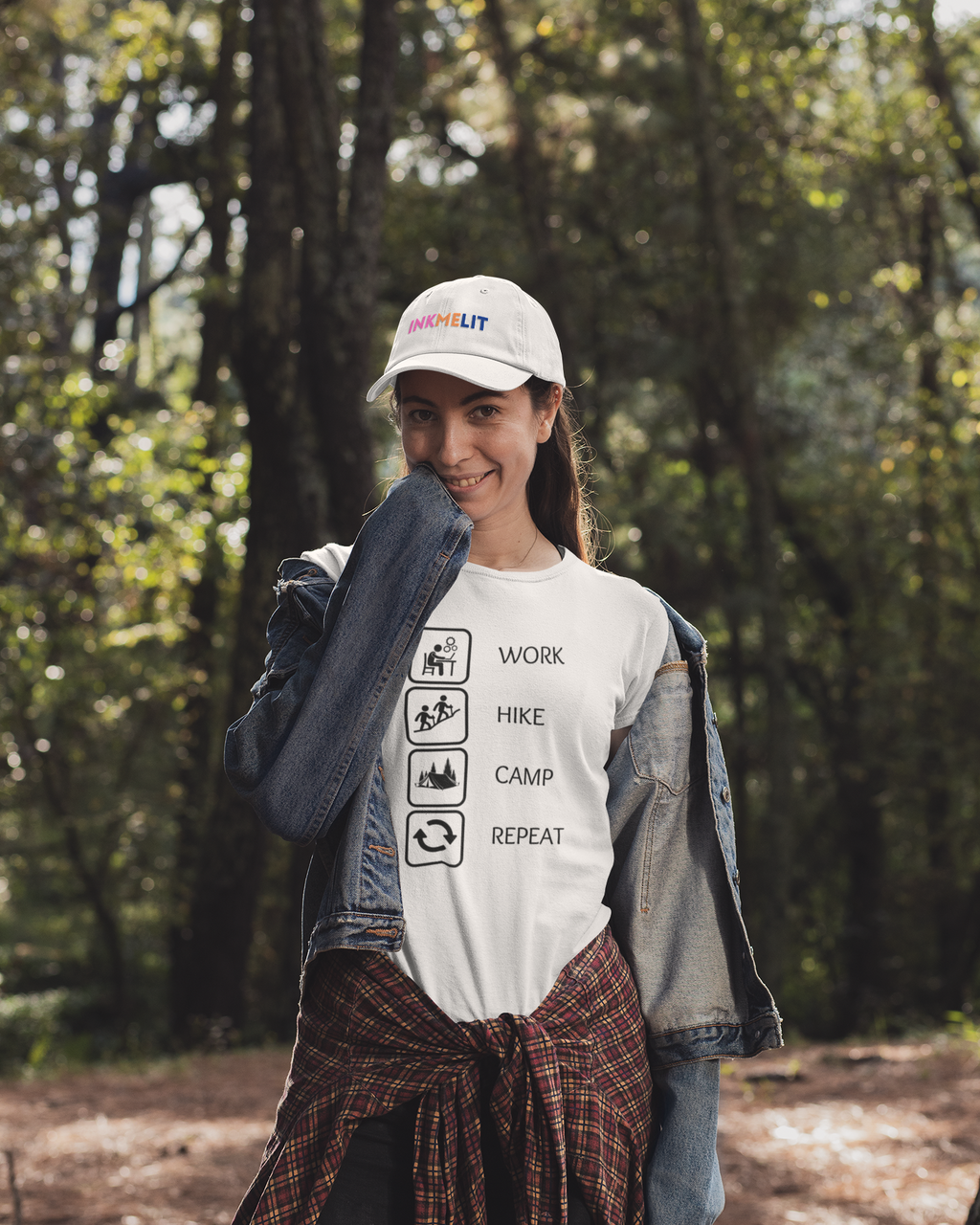 Person wearing a cap and t-shirt with outdoor-themed graphics in a forest setting
