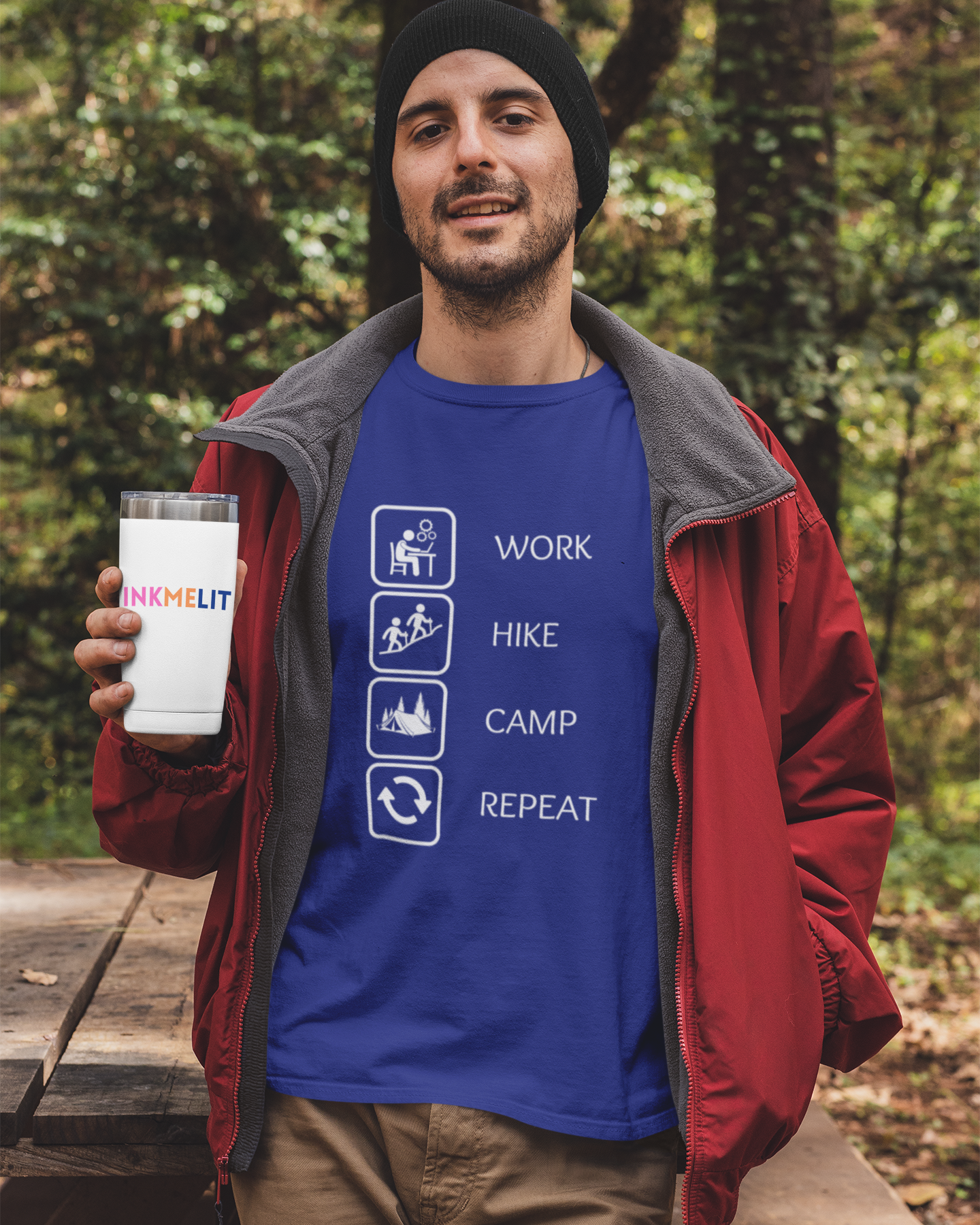 Man holding a mug with a blue shirt featuring outdoor activities in a forest setting